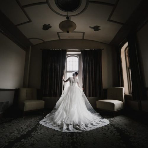bride standing in front of window by Michael Carr Ohio Wedding and Engagement Photographer