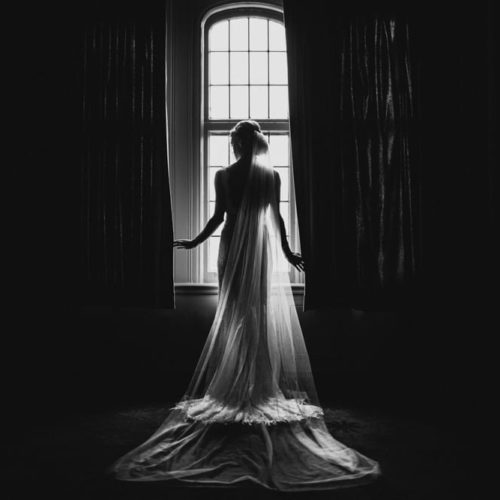bride standing at window by Michael Carr Ohio Wedding and Engagement Photographer