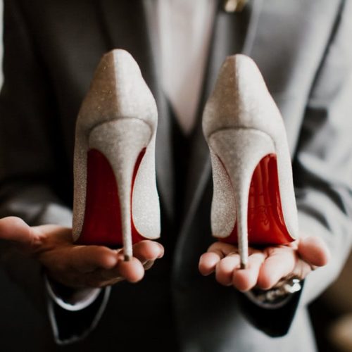groom holding brides high heels by Michael Carr Ohio Wedding and Engagement Photographer