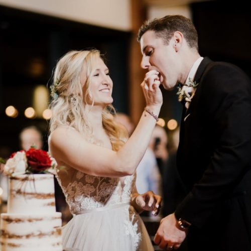 bride and groom eating cake by Alex Grodkiewicz Dayton Ohio Wedding and Engagement Photographer