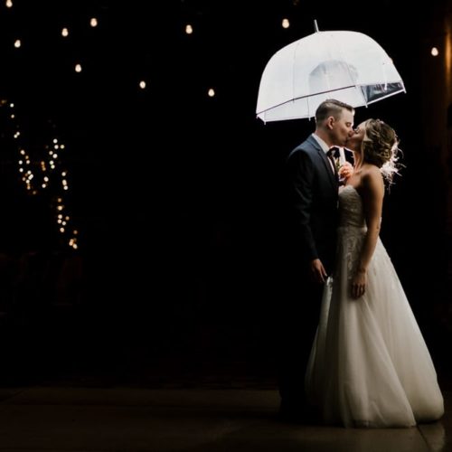 bride and groom kissing under umbrella by Dayton Ohio Wedding Photographer Josh Ohms