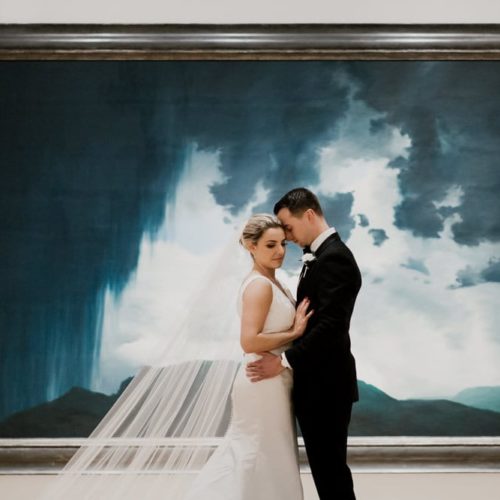 bride and groom in front of large painting by Dayton Ohio Wedding Photographer Josh Ohms