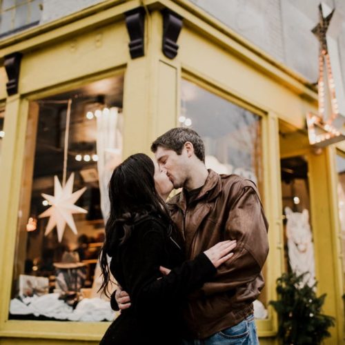 couple kissing in front of store by Dayton Ohio Wedding Photographer Josh Ohms