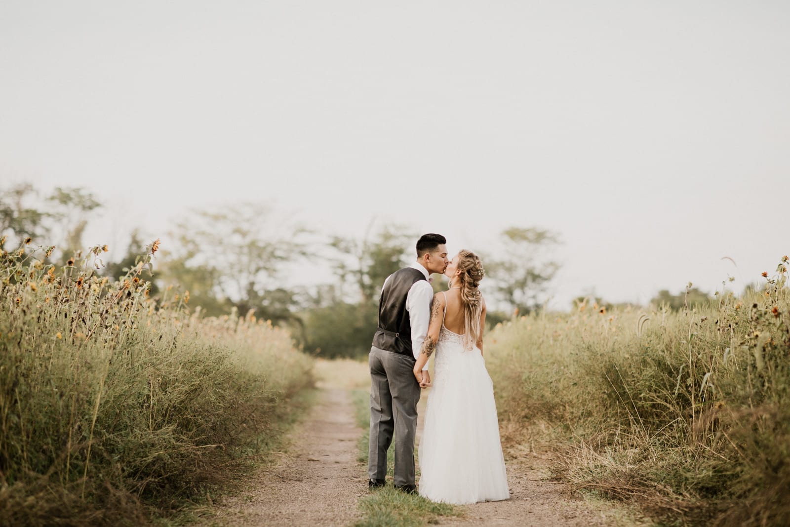 bride and groom kissing in the field by Dayton Ohio Wedding Photographer Josh Ohms