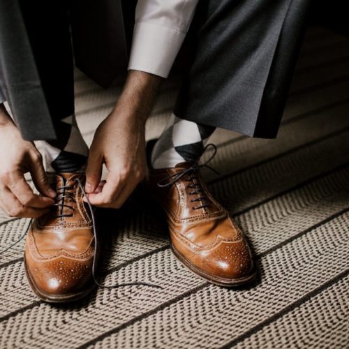 close up of groom putting shoes on by Dayton Ohio Wedding Photographer Josh Ohms