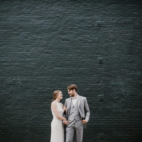 bride and groom in front of black wall by Dayton Ohio Wedding Photographer Josh Ohms