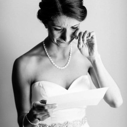 bride crying while reading a note by Dayton Ohio Wedding Photographer Josh Ohms