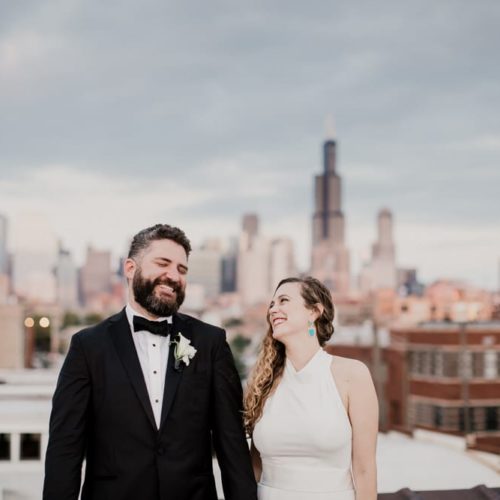 bride and groom laughing with city skyline in background by Dayton Ohio Wedding Photographer Josh Ohms