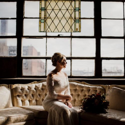 bride sitting on a couch by Dayton Ohio Wedding Photographer Josh Ohms