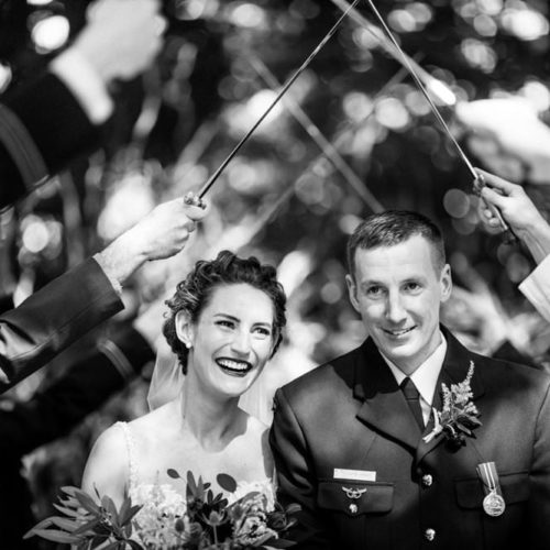 bride and groom walking under saber arch by Dayton Ohio Wedding Photographer Josh Ohms