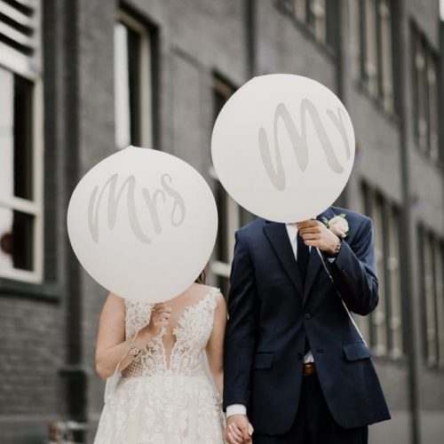 bride and groom holding balloons in front of face by Dayton Ohio Wedding Photographer Josh Ohms