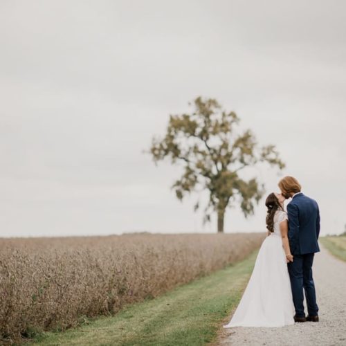 bride and groom kissing on country road by Dayton Ohio Wedding Photographer Josh Ohms