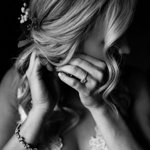 bride putting on earrings by Dayton Ohio Wedding Photographer Josh Ohms