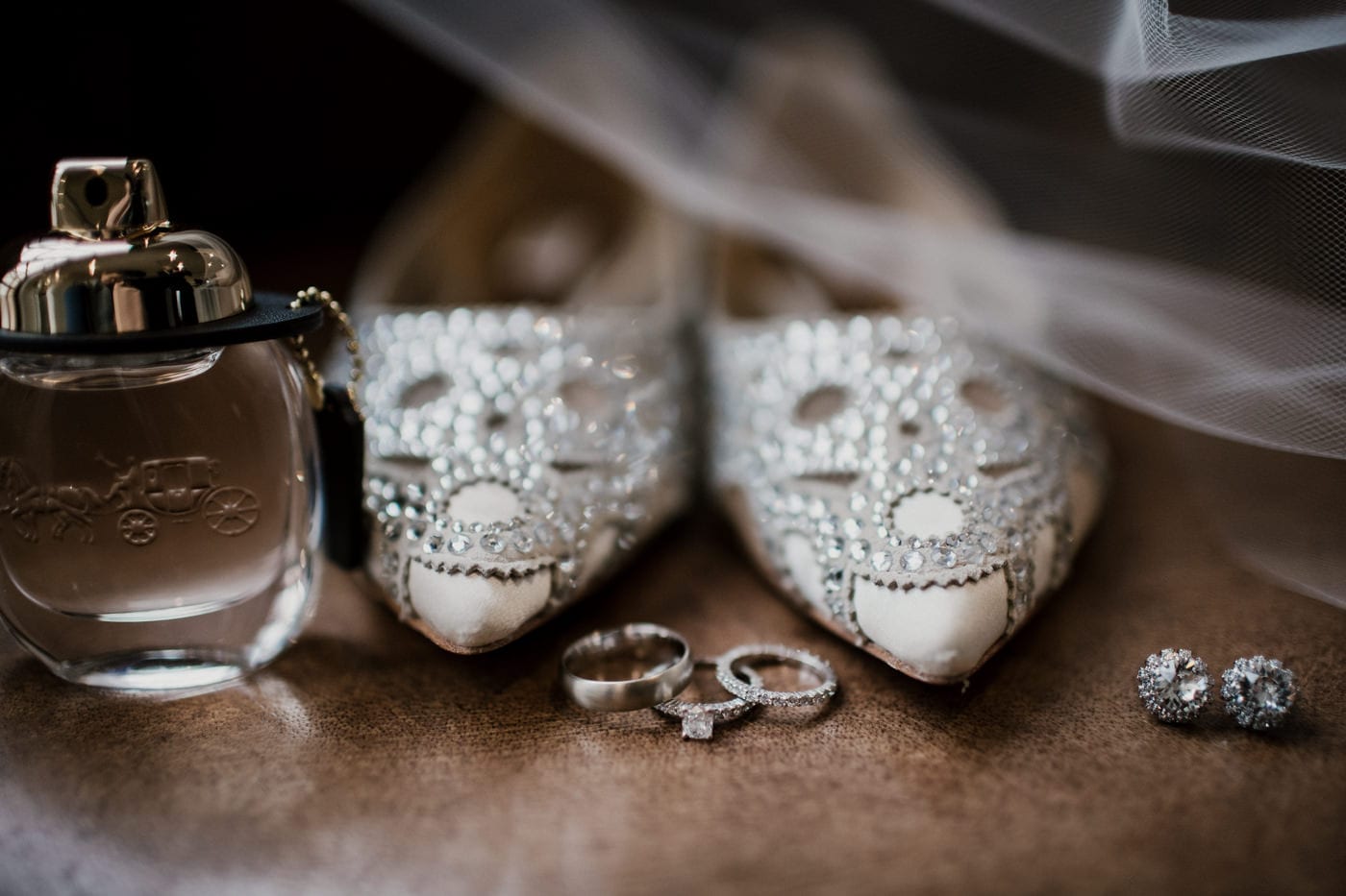 brides beaded shoes wedding bands and earrings at black tie winter wedding