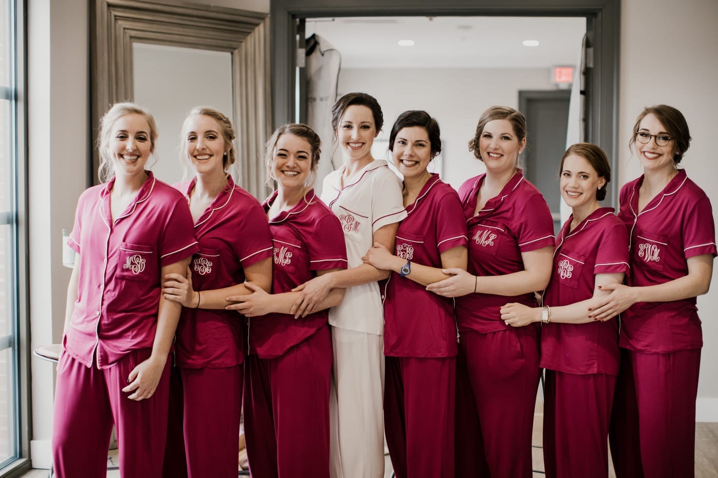 bride and bridesmaids in matching getting ready pajamas at black tie winter wedding