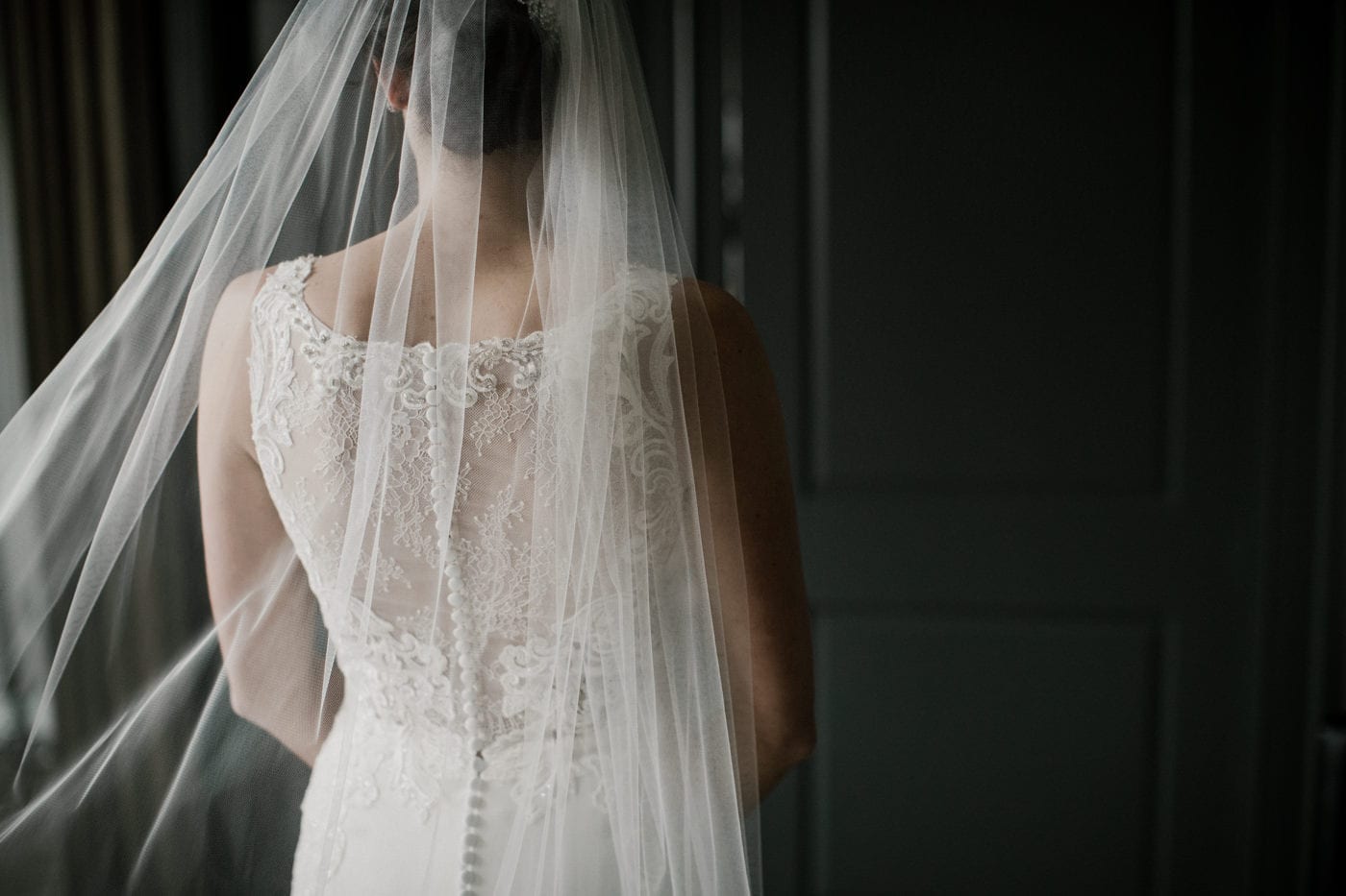 close up of the back of brides dress at black tie winter wedding