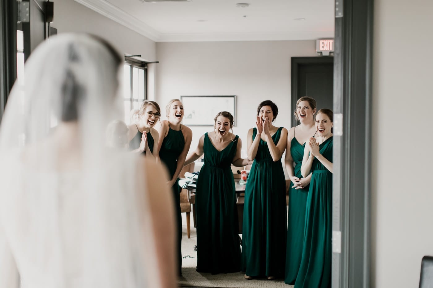 bridesmaids react to seeing bride for first time at black tie winter wedding