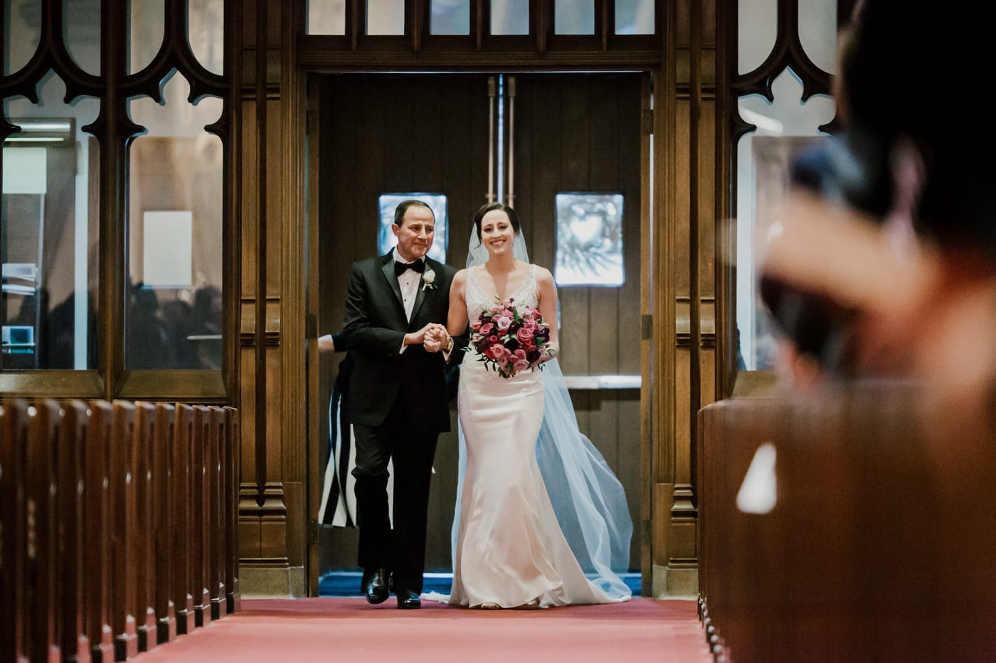 father walks daughter down aisle at black tie winter wedding