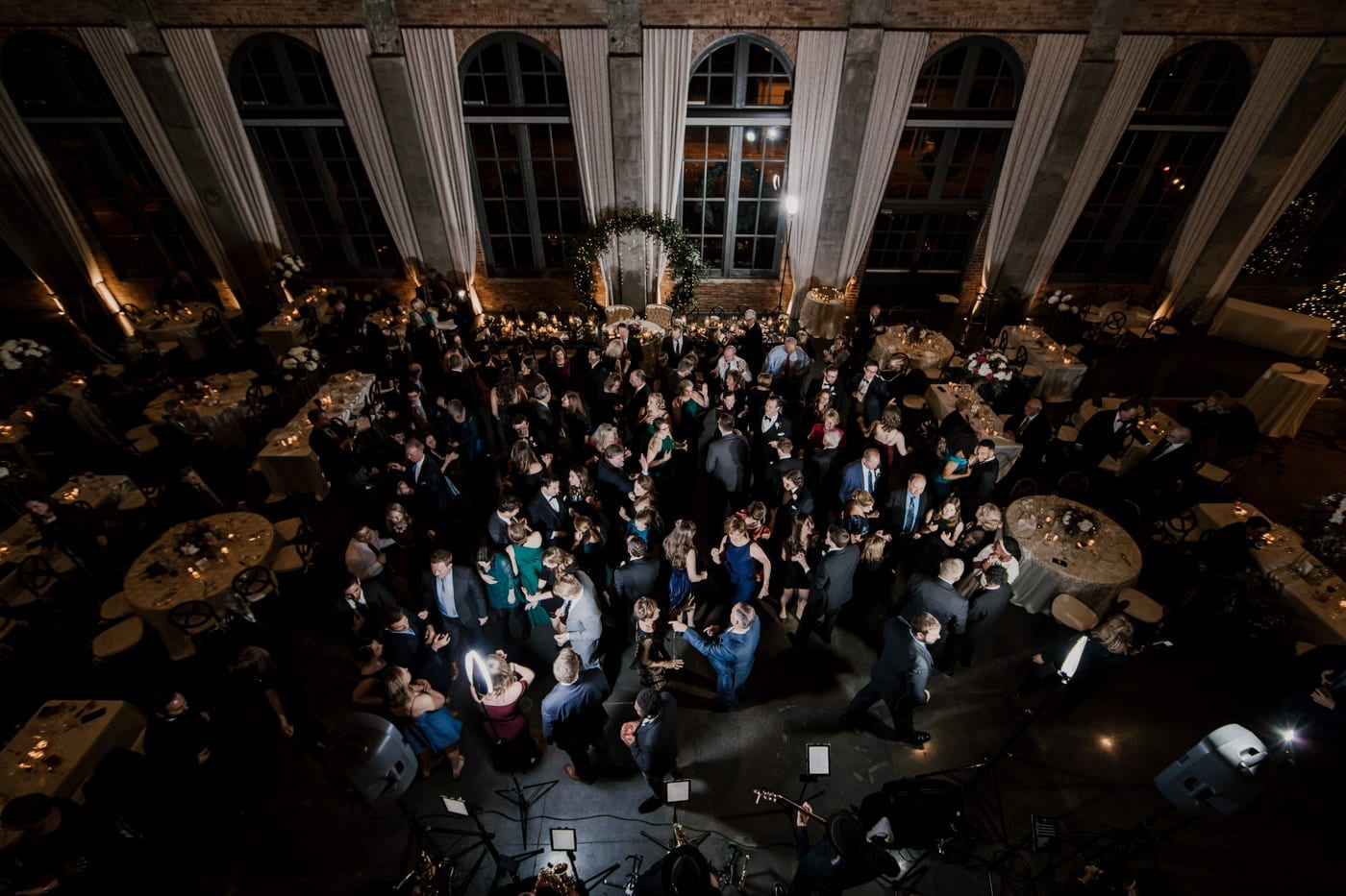 overhead shot of reception guests dancing at black tie winter wedding