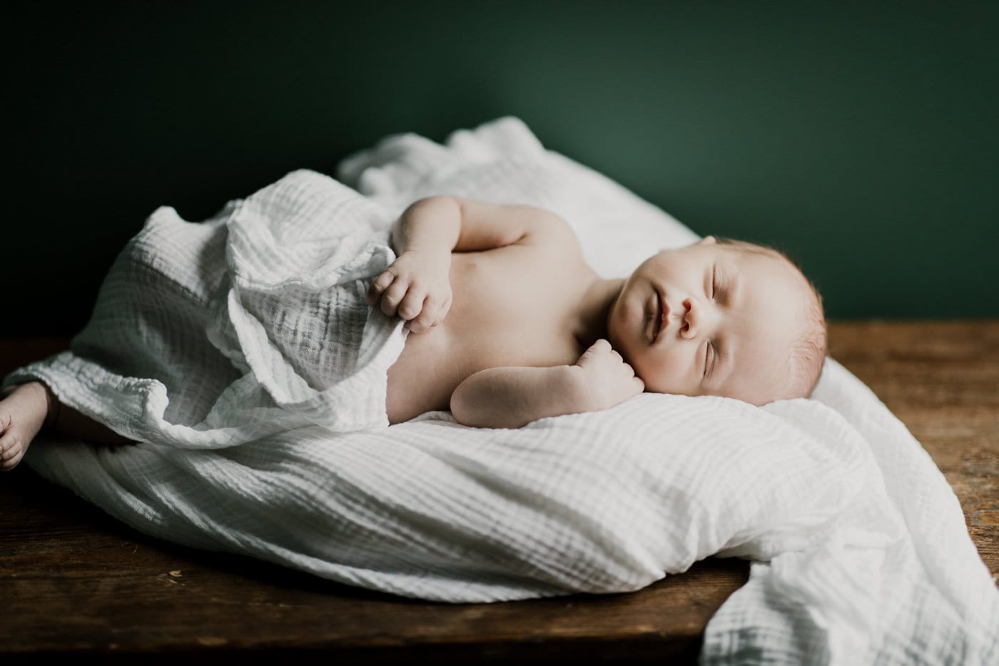 new born laying on white blanket sleeping - in-home newborn session