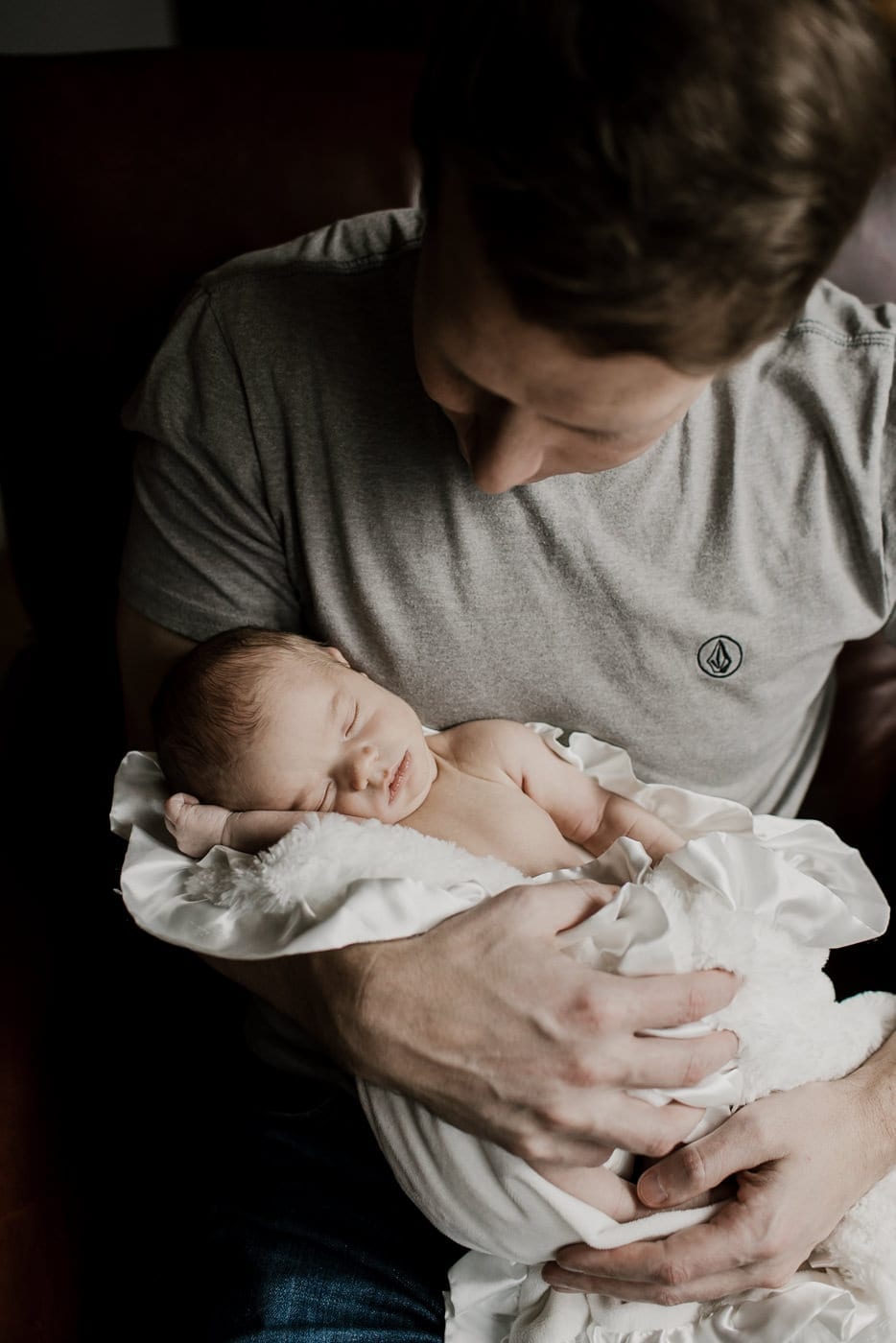 dad holding sleeping baby - in-home newborn session
