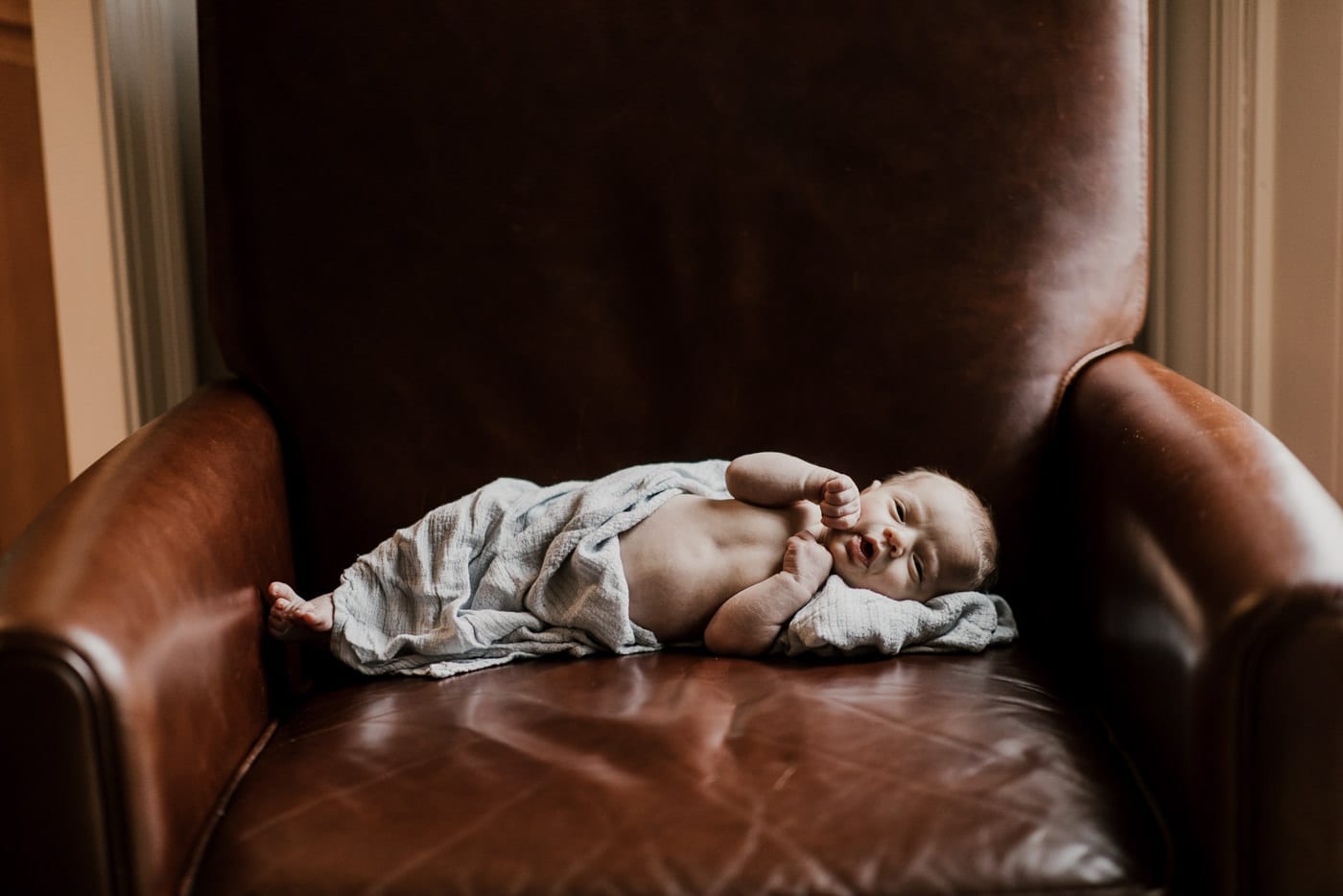 baby on leather chair - in-home newborn session