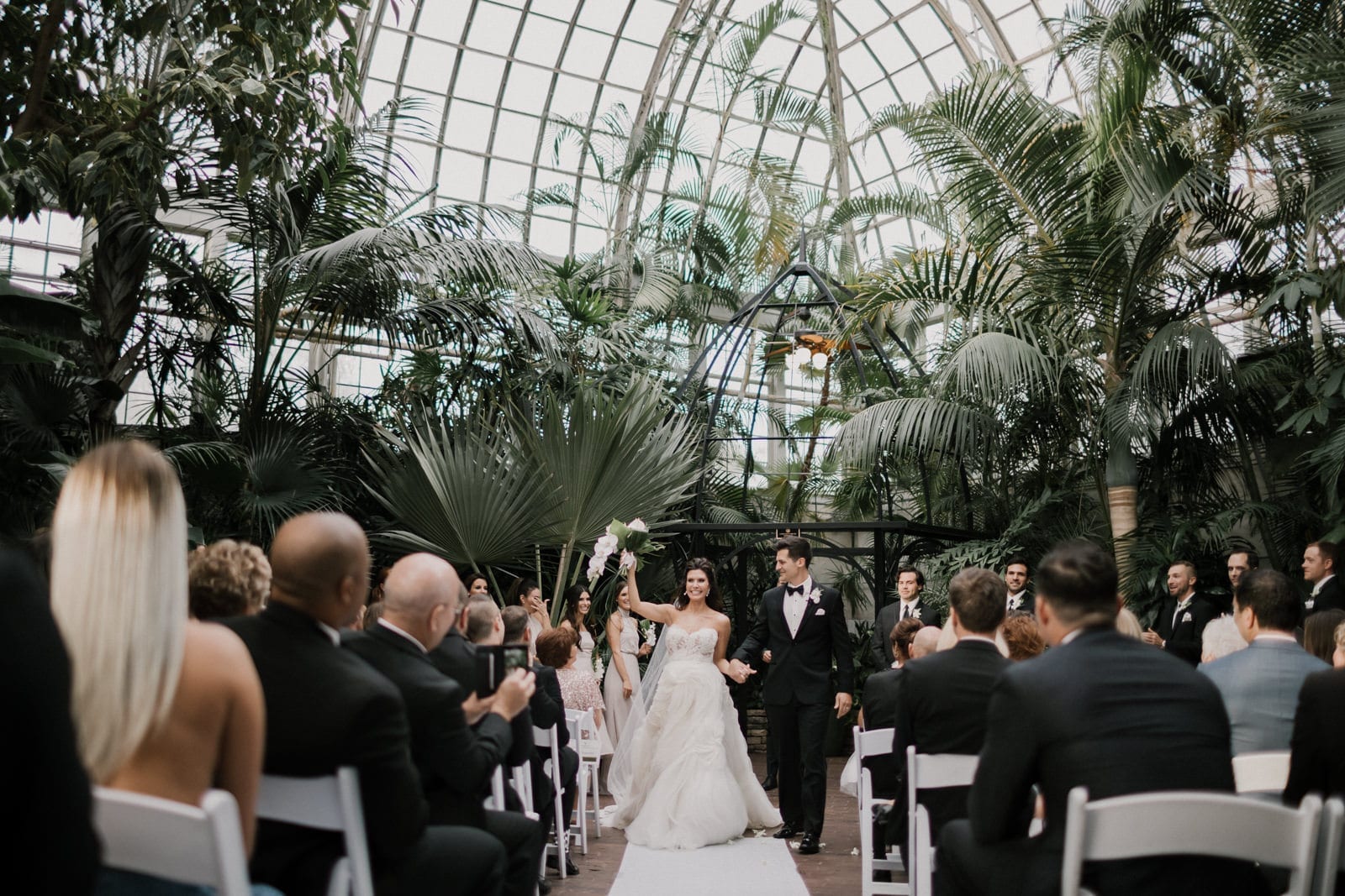 bride and groom leaving ceremony at Franklin Park Conservatory Wedding by Columbus Wedding Photographer