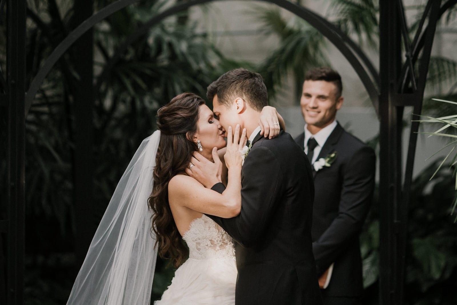 bride and groom ceremony kiss at Franklin Park Conservatory Wedding by Columbus Wedding Photographer
