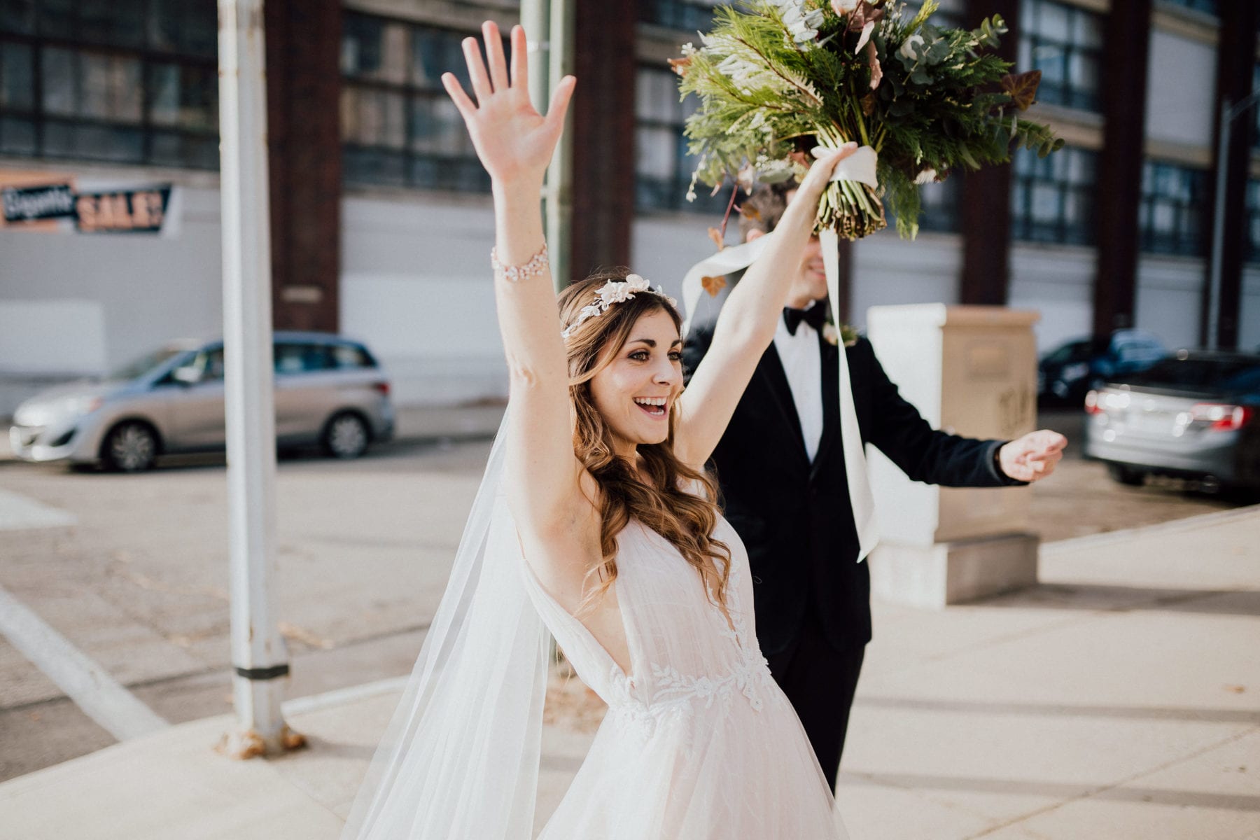 Bride cheers for her friends after ceremony