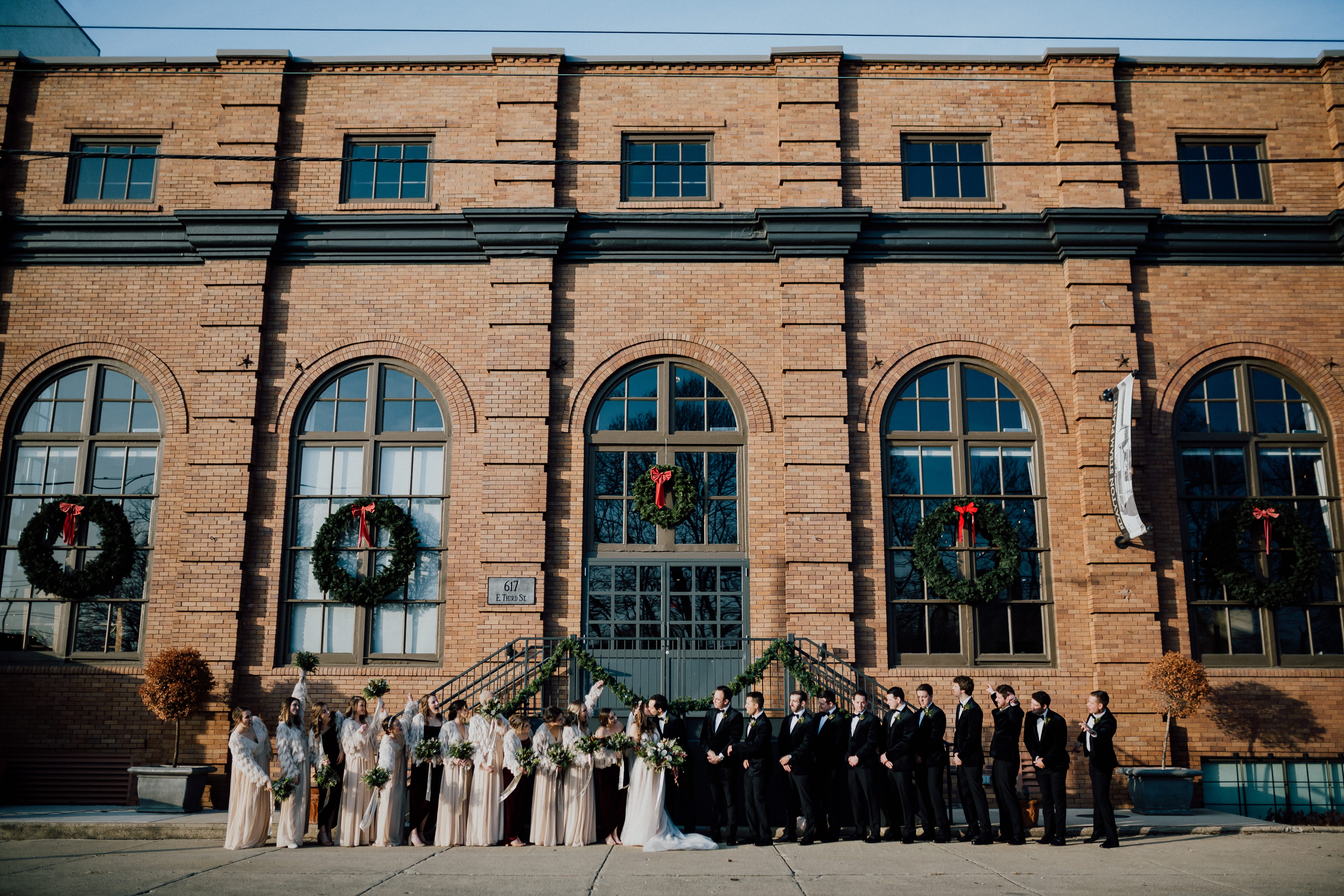 Bridal party stands outside venue