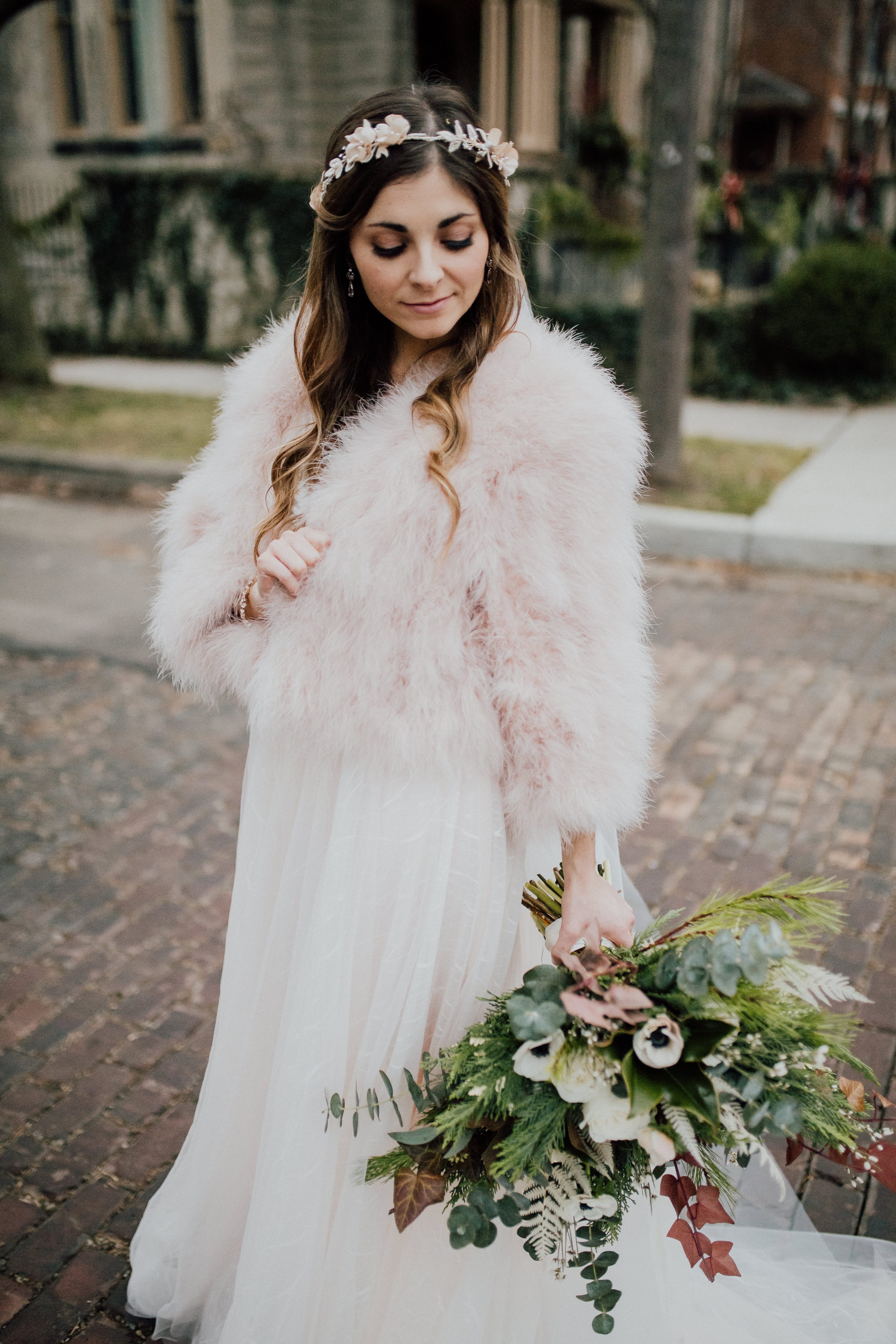 Bride poses with wedding flowers
