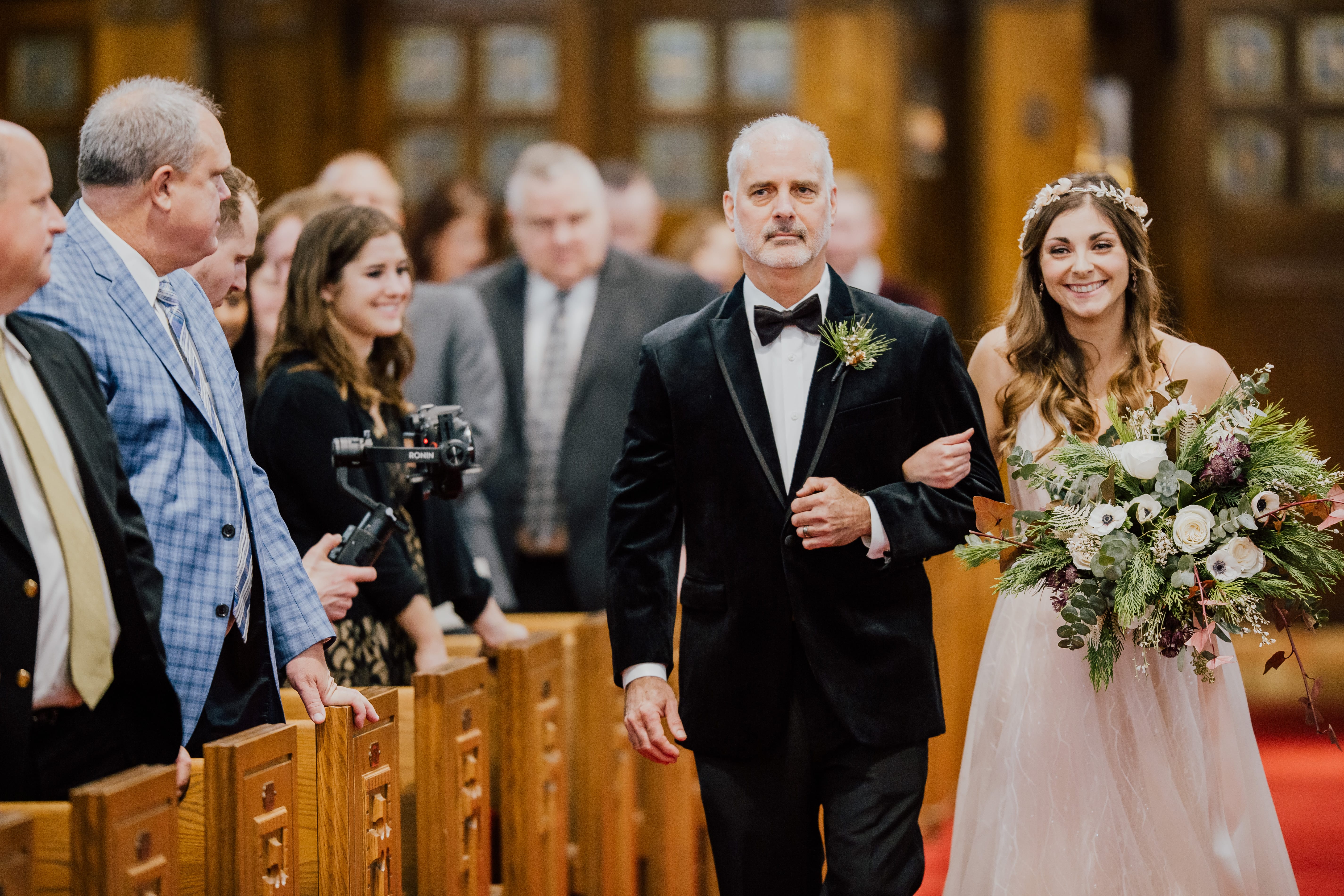 Bride walks with father down the aisle