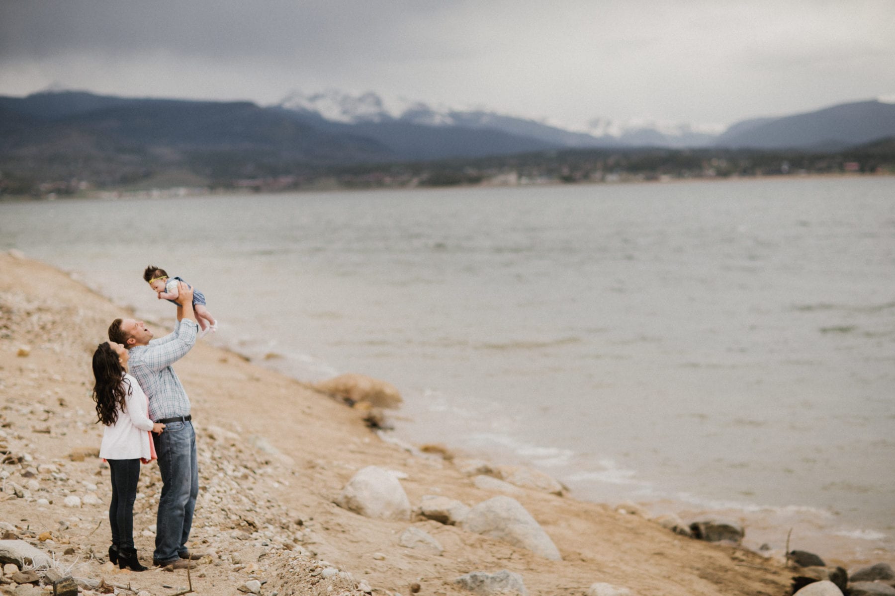 dad holds baby above his head at Grand Lake Colorado Family Portraits - Destination Photographer
