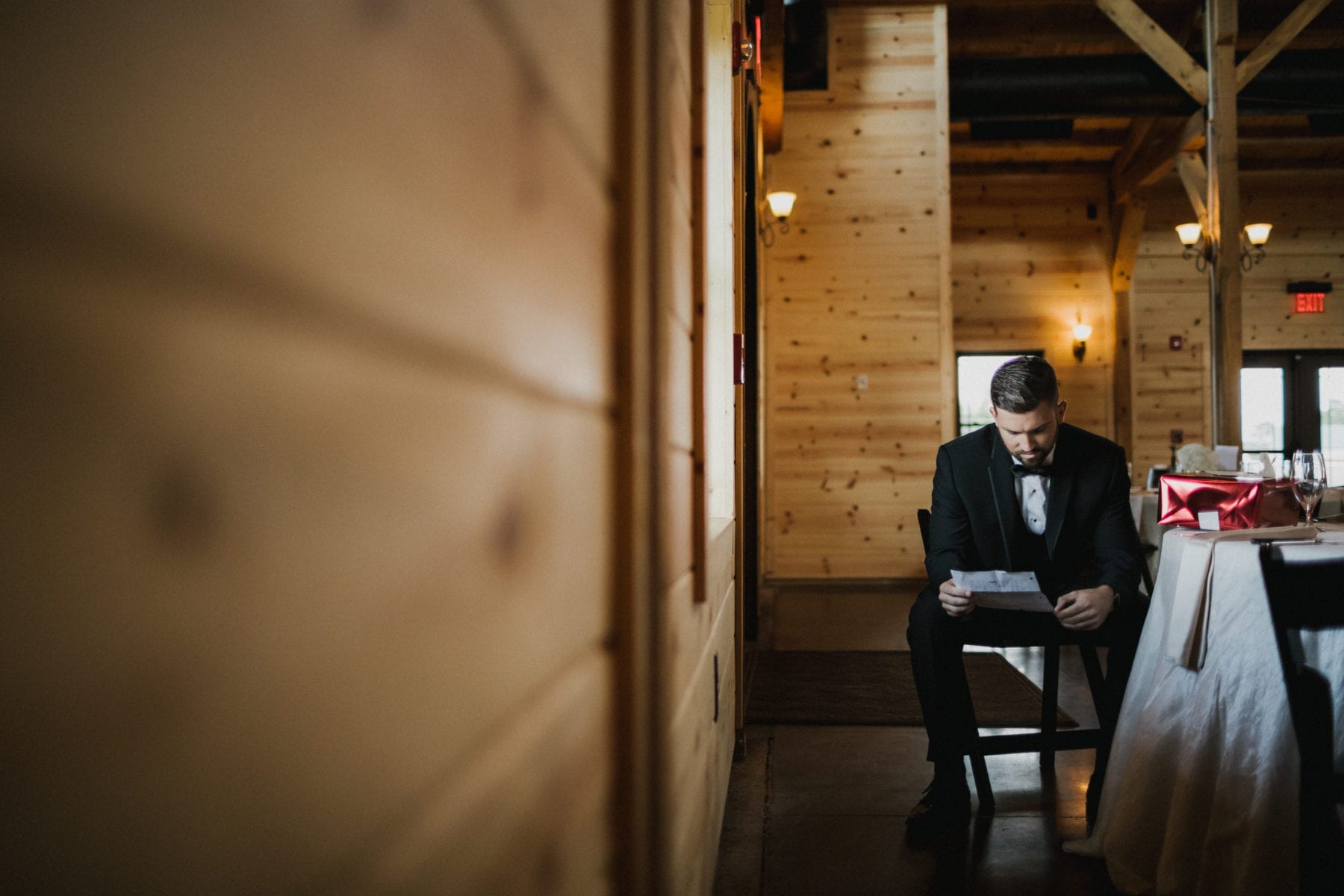 groom reads a letter at Rolling Meadows Ranch Wedding - Cincinnati Wedding Photographer
