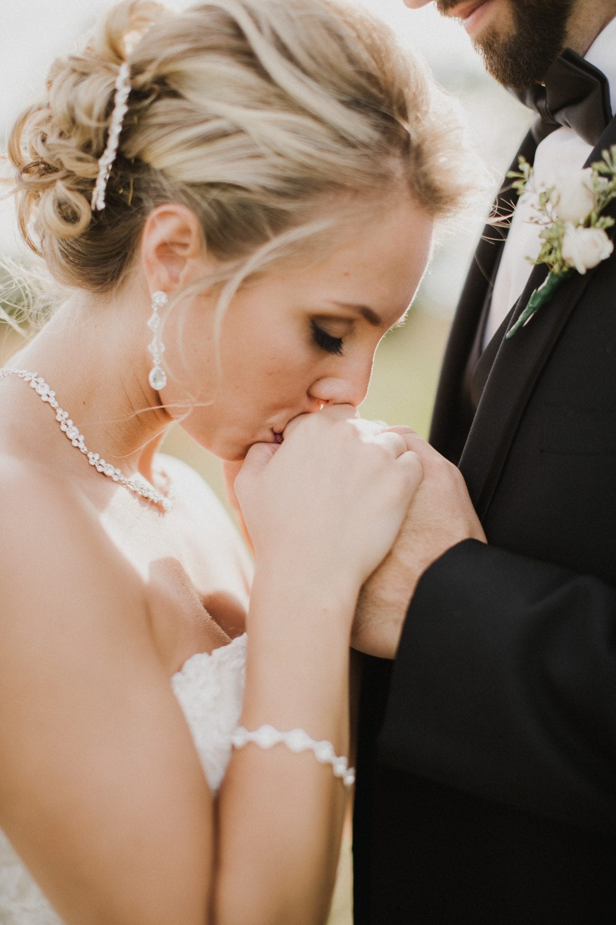 bride kisses grooms hand at Rolling Meadows Ranch Wedding - Cincinnati Wedding Photographer
