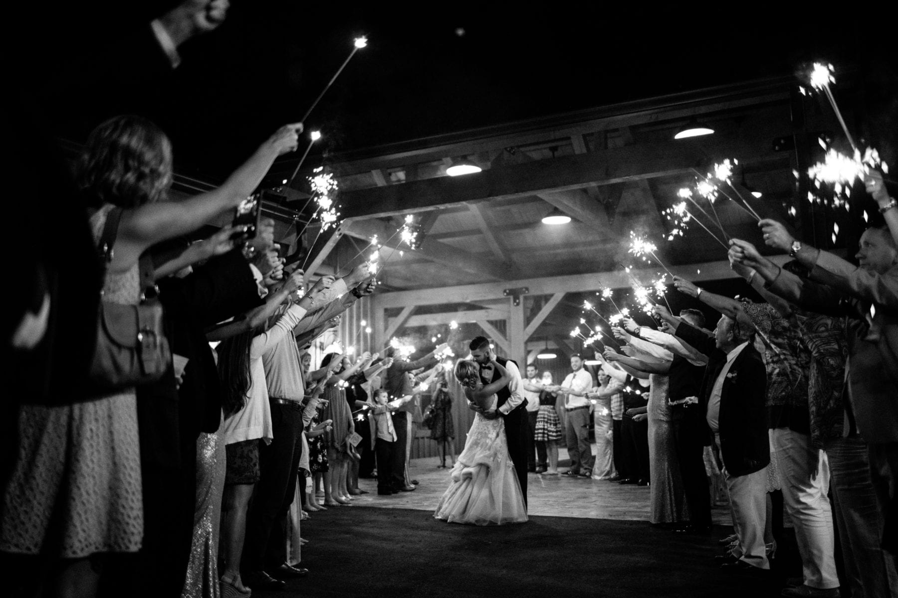 bride and groom kiss under sparkler at Rolling Meadows Ranch Wedding - Cincinnati Wedding Photographer