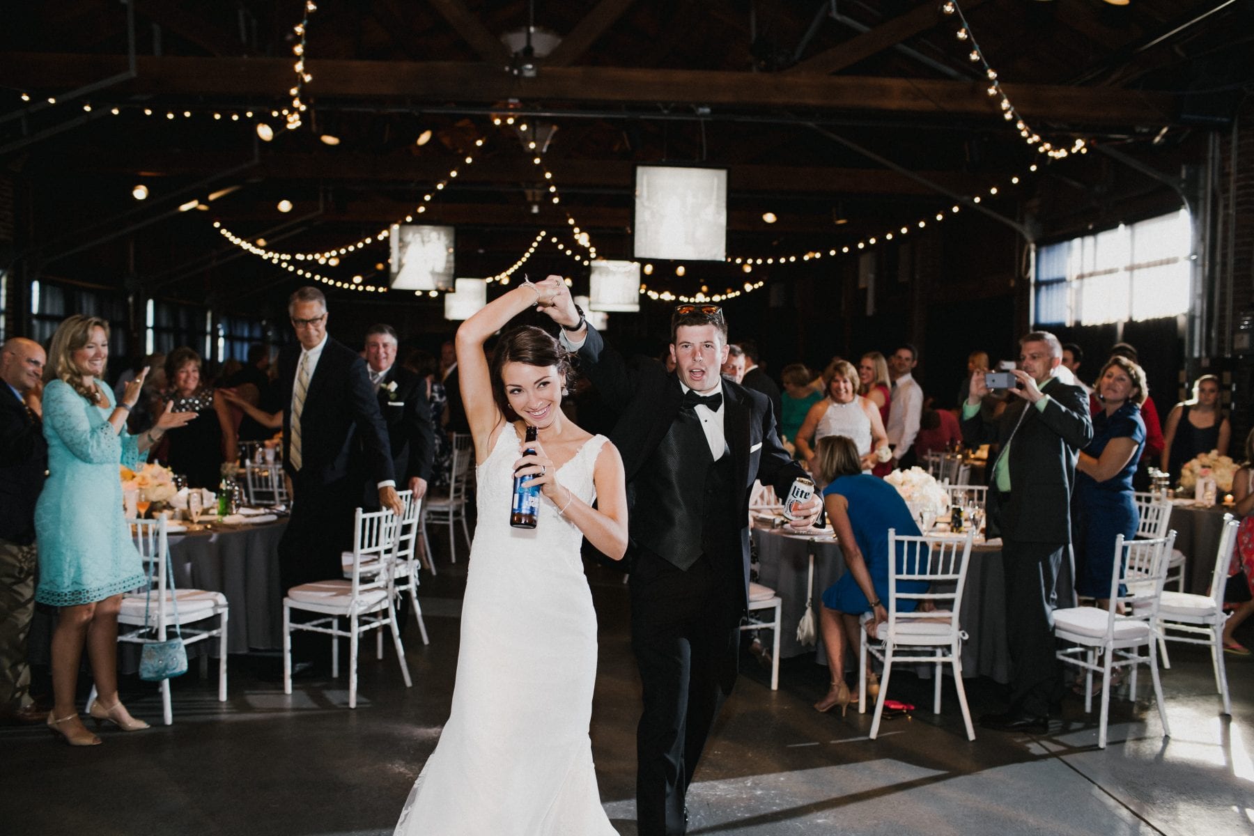 bride and groom celebrating at the reception at Top of the Market Wedding - Dayton Wedding Photographer