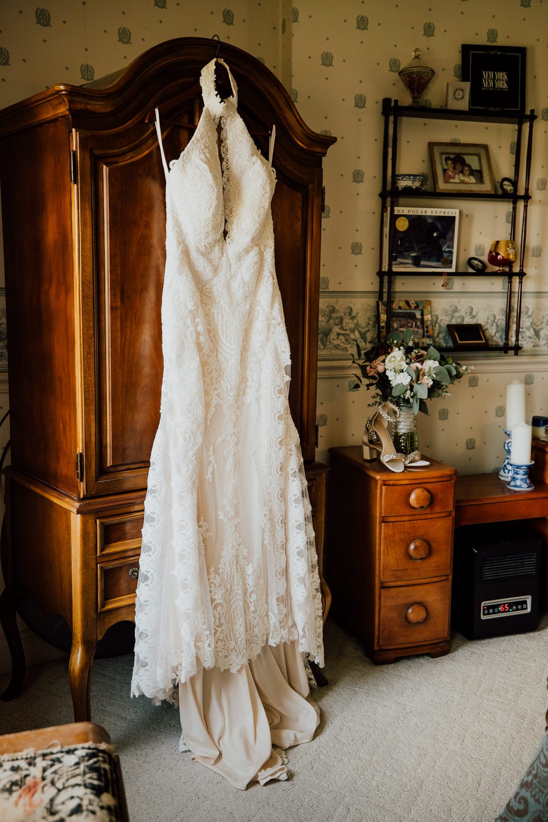 Wedding dress hangs on antique wardrobe