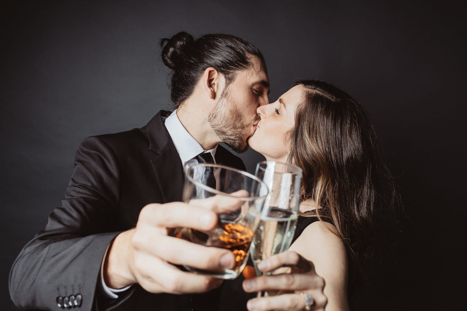 Couple kisses and toasts the camera