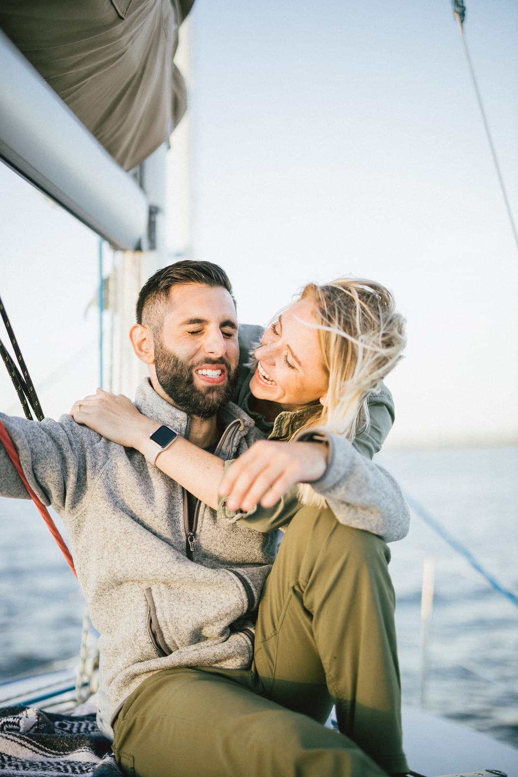 couple laughs together while sailing