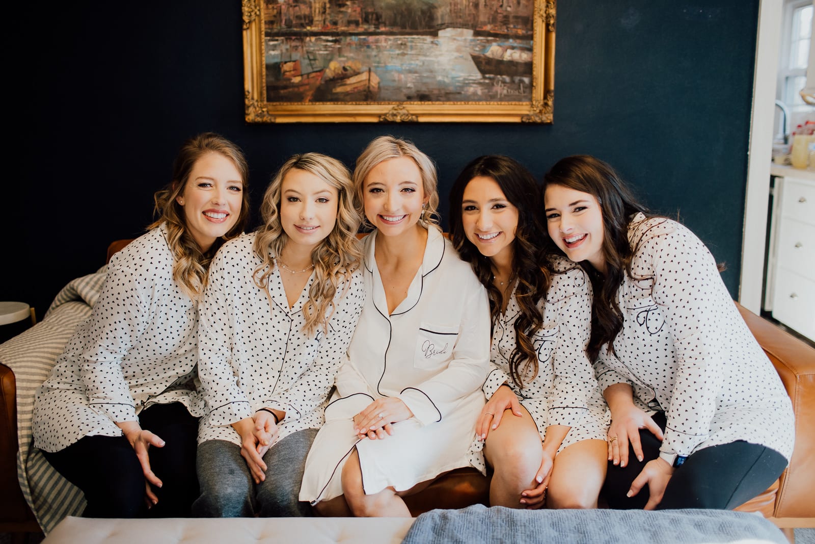 Bridal party cuddles on couch
