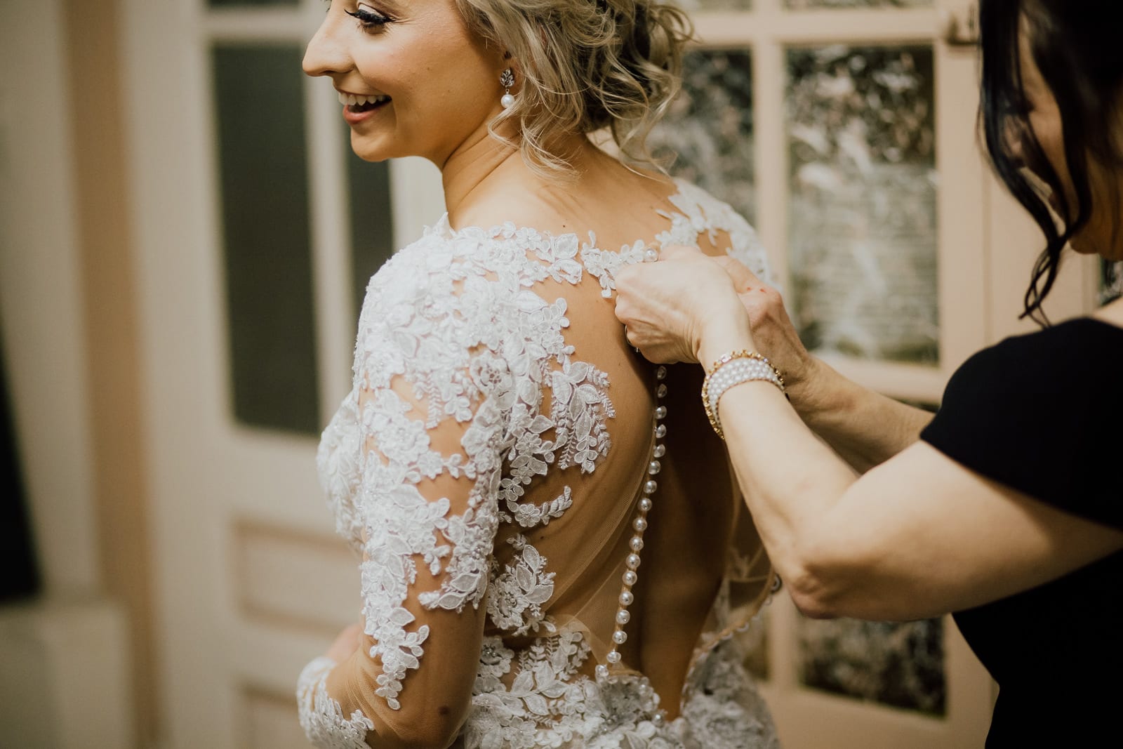 Bride's mother buttons wedding dress