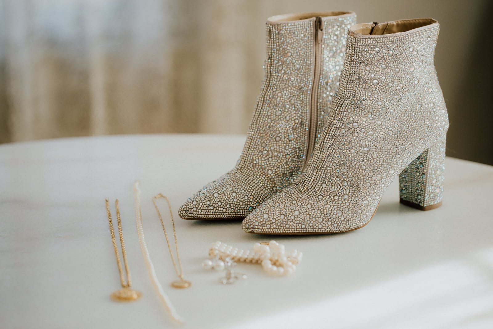 details of wedding jewelry, pearls, and shoes