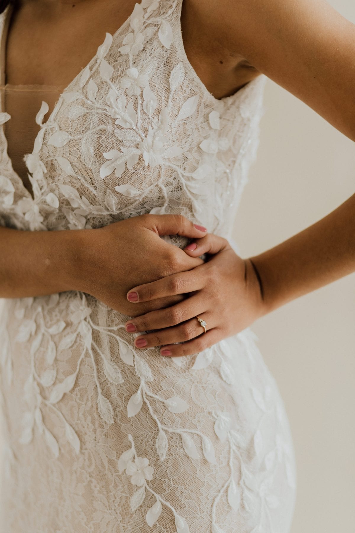 Details of bride's ring and wedding dress