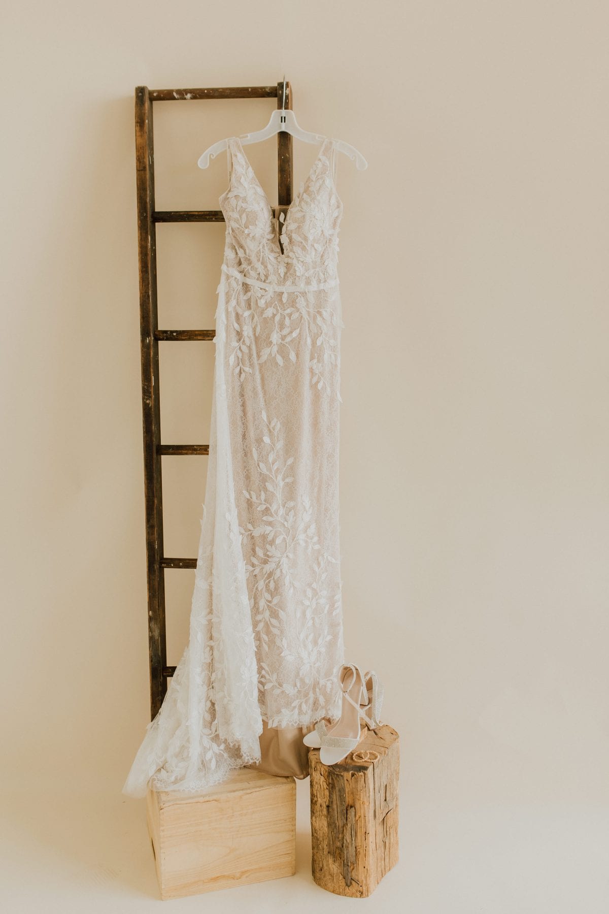 Wedding gown hangs in studio