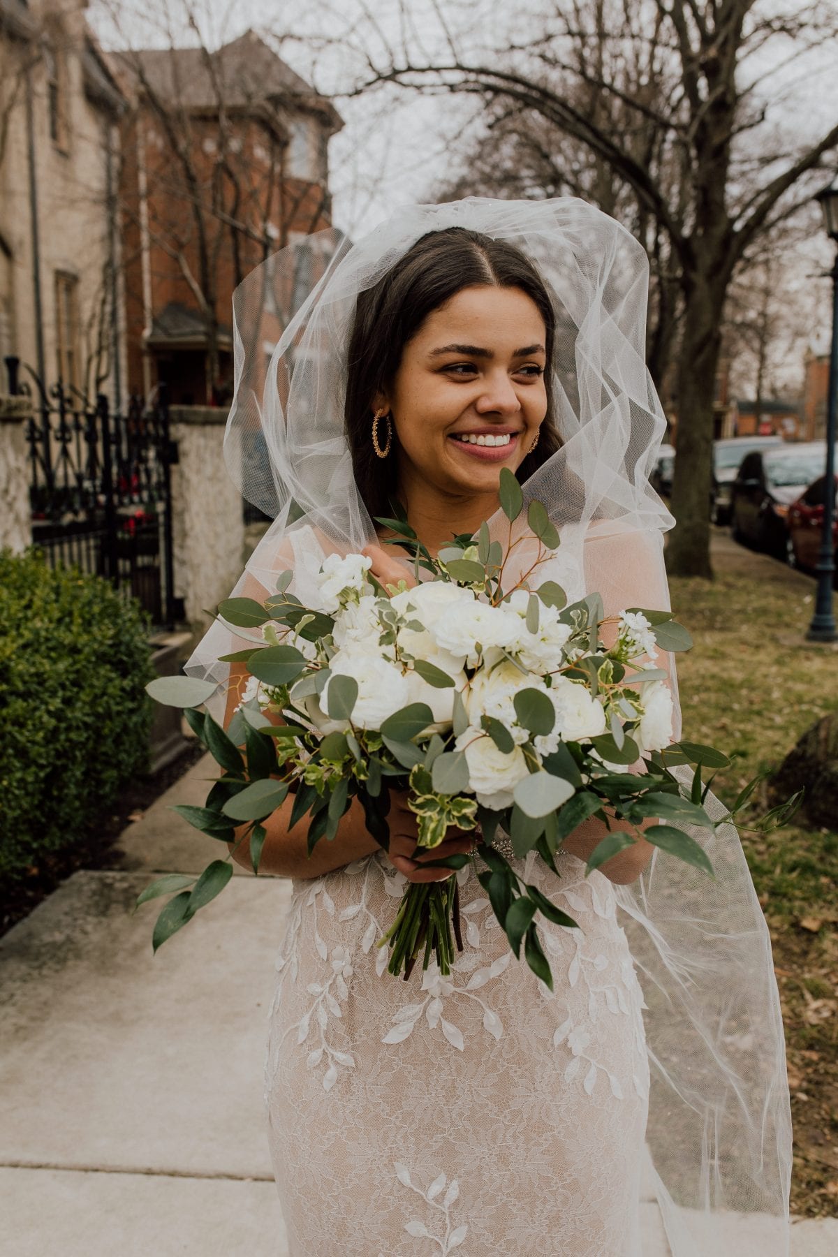 Bride laughs as wind blows her veil