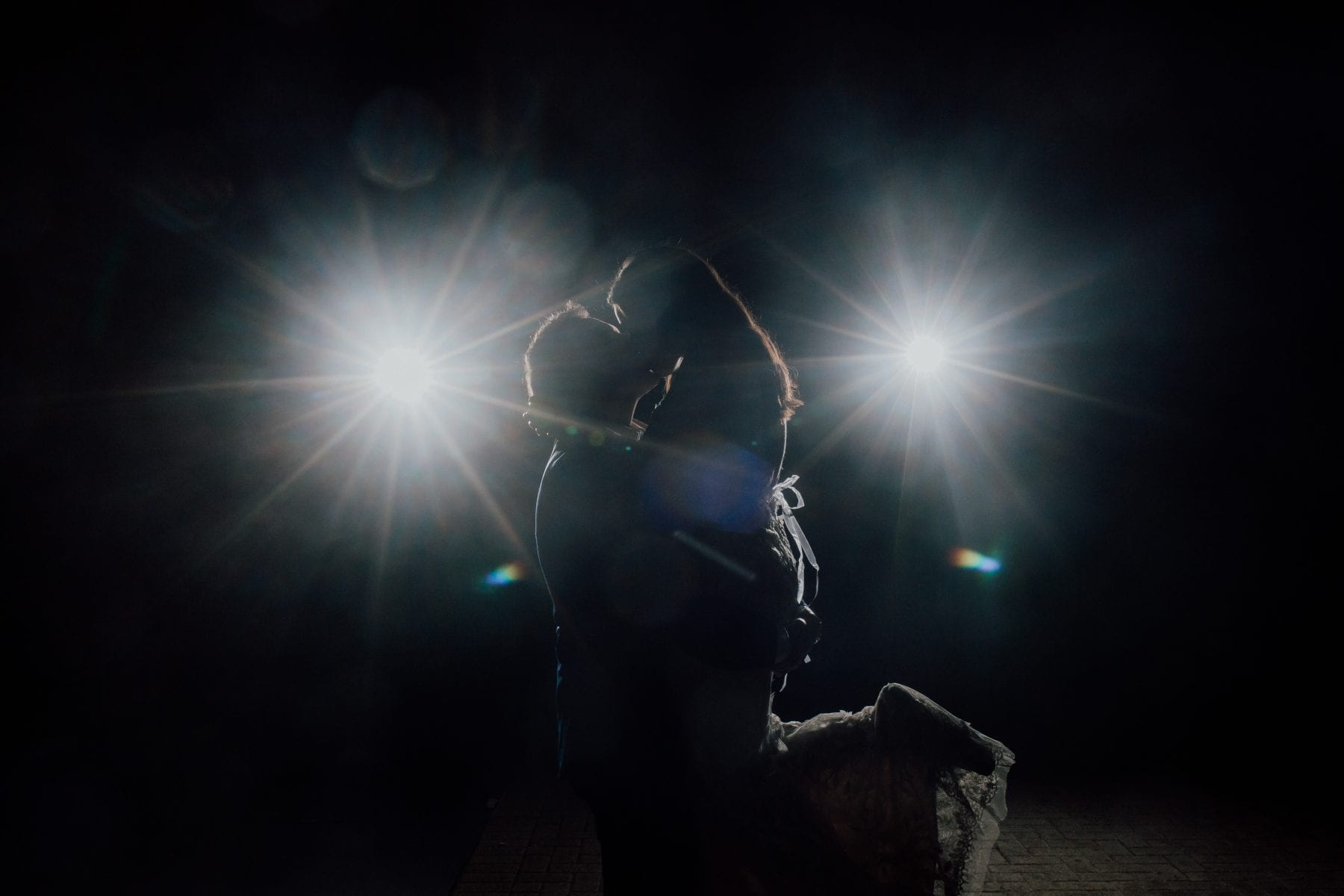 Bride and Groom Kiss in front of lights